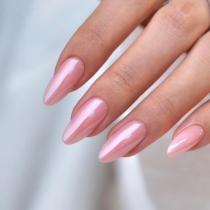 Perfect pink almond nails by decode beauty on hand showing ultra glossy high shine builder gel nails design 
