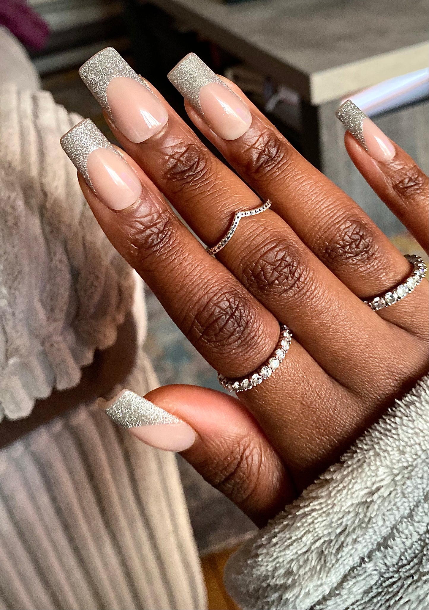 Decode beauty builder gel press on style flashing lights on hand with silver jewellery. A silver reflective glitter gel nail styles that glow in the dark 