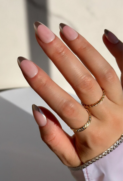 Hand wearing Decode beauty silver chrome French tip nails design 