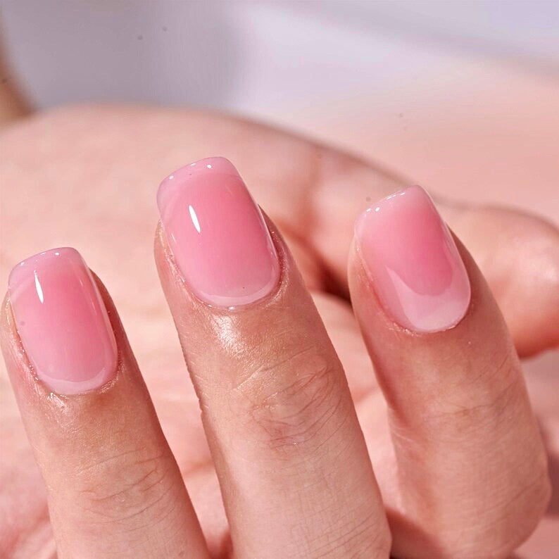 Hand showing light pink gel nails the best pink nail shade